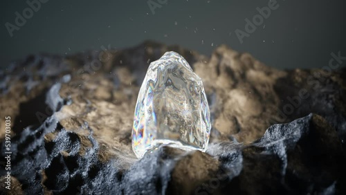 Raw crystal or diamond on the rocks in a dark cave. Shiny rough uncut gem.