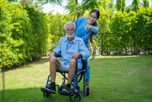 Nurses help and encourage for senior man on wheelchair in their home,Therapy physical rehab exercises.