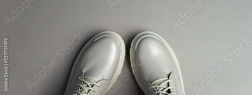 beige women's shoes on a gray background. Autumn shoes. Horizontal image. Banner for insertion into site. Place for text cope space.