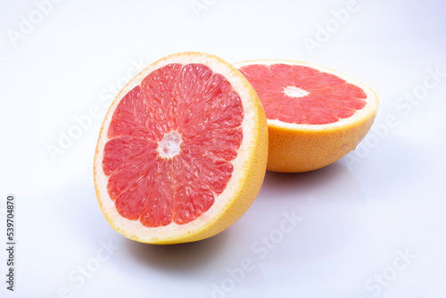 juicy, fresh red grapefruit on a grey, two halves of the fruit