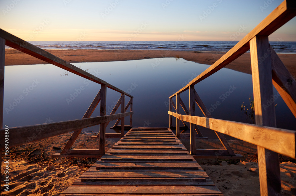 Wooden path ramp going into water, selective focus Wooden path ramp going into water, selective focus