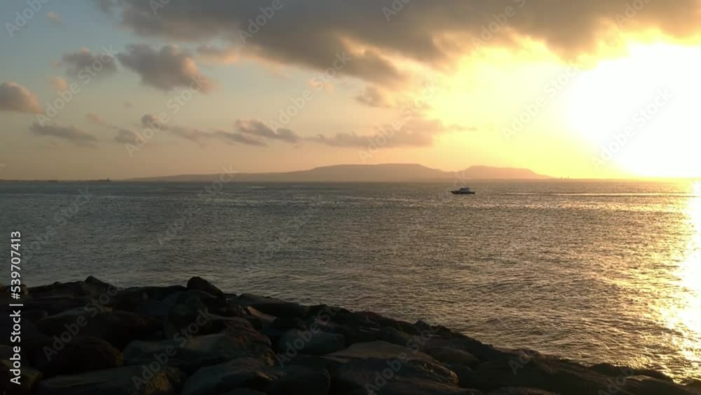 Beautiful sunrise at the beach with dramatic sky and clouds.