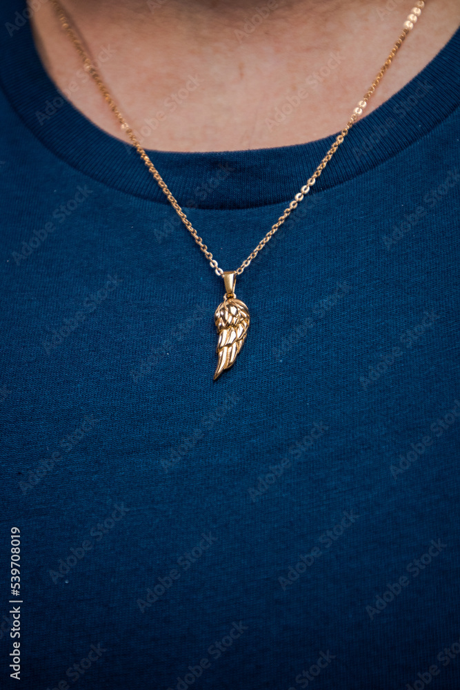 Gold necklace on blue background jewelry fashion Gold necklace on blue background jewelry fashion