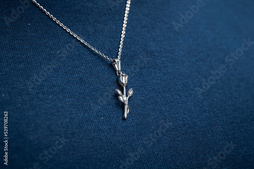 Silver necklace on blue background jewelry fashion 