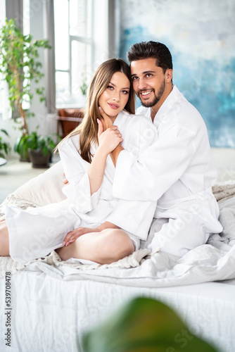 Romantic young couple spending morning together in bed. Two beautiful people enjoying valentines day. Relax. Date. Love. © neonshot