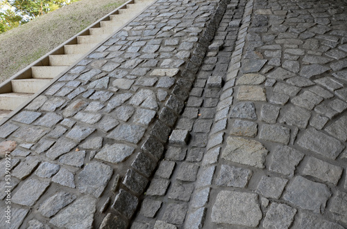 freeway bridge drainage. A sound-absorbing wall with holes lets water through. gutters collect water from gutter of water line. pipe with flexi rubber connection. slowing down flow of water roughening