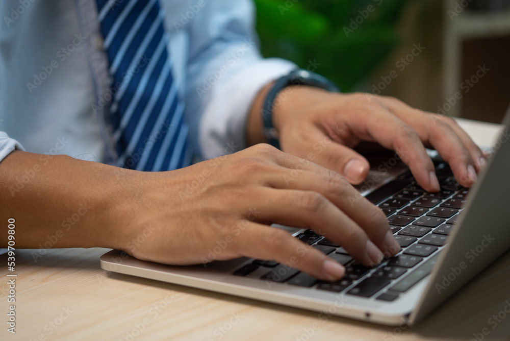 male hands typing on keyboard laptop at the office.search information form internet working on computer concept for technology. male hands typing on keyboard laptop at the office.search information form internet working on computer concept for technology.