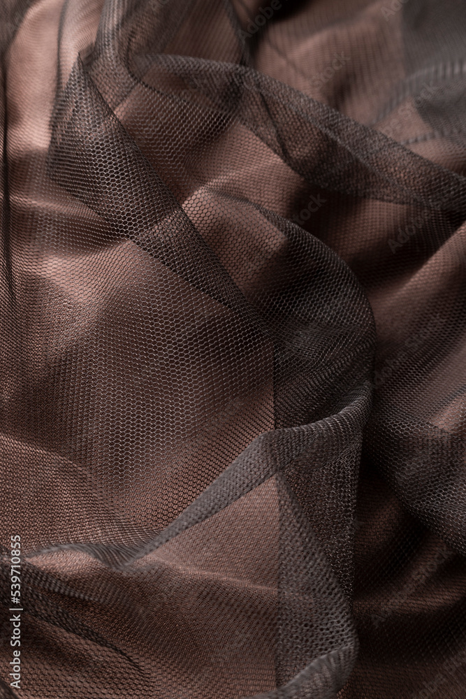 Fashionable brown tulle cloth, sofisticate textile close up view Fashionable brown tulle cloth, sofisticate textile close up view