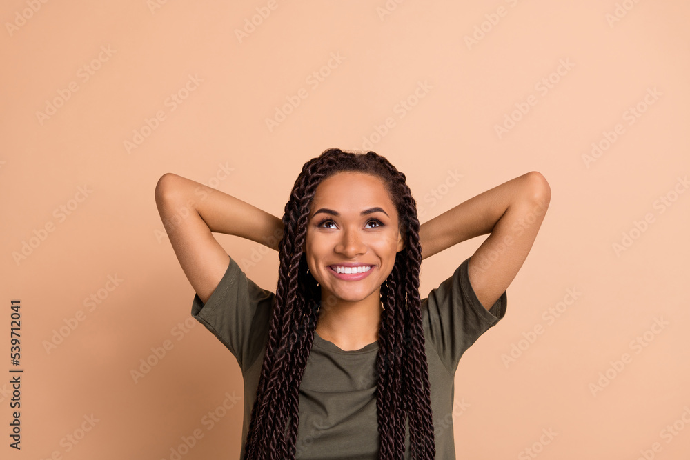 Portrait of cheerful dreamy female look empty space generate creative ideas isolated on beige color background Portrait of cheerful dreamy female look empty space generate creative ideas isolated on beige color background