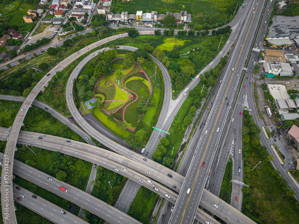 Aerial view city transport junction cross road with green public park transport industry
