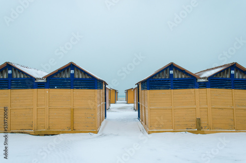 I capanni di uno stabilimento balneare del Lido di Venezia coperti dalla neve in una fredda giornata invernale  photo