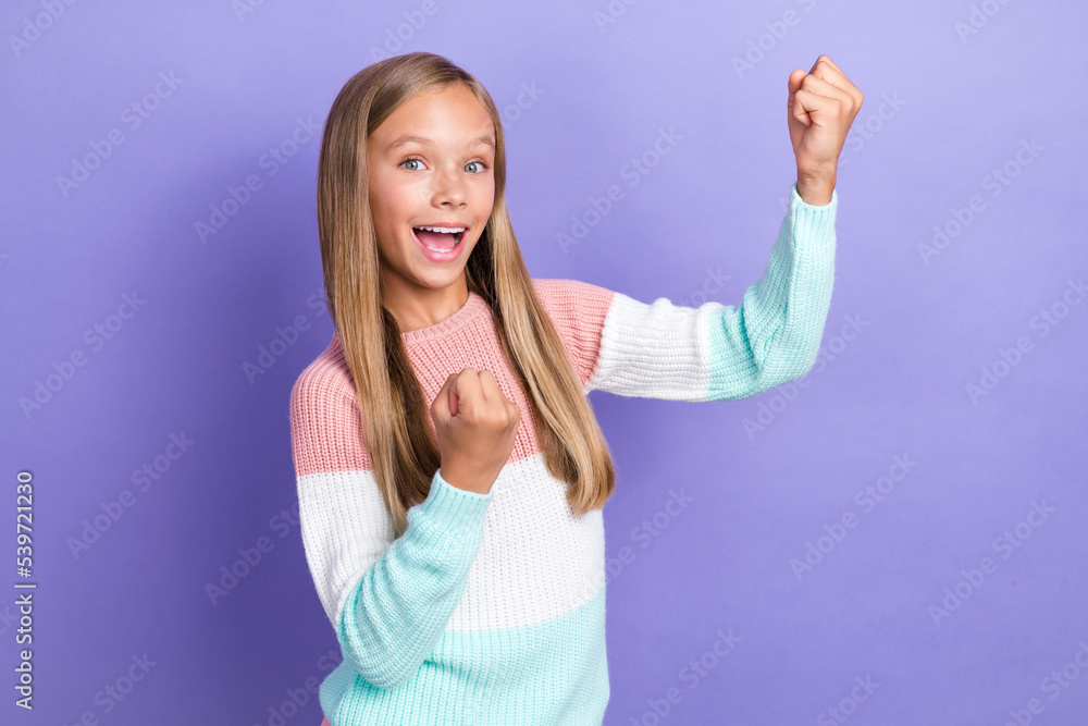 Photo of cheerful glad girl wear stylish jumper raise hand rejoice triumph good mark lesson isolated on purple color background Photo of cheerful glad girl wear stylish jumper raise hand rejoice triumph good mark lesson isolated on purple color background