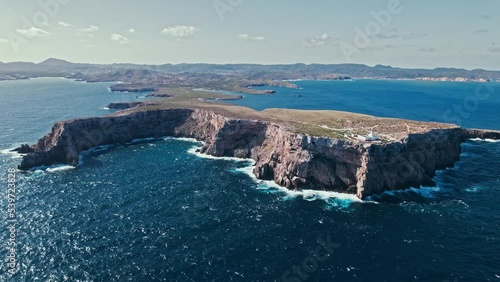Drone view of a lighthouse scenic viewpoint offering dramatic sea views. Aerial view of the most northerly point of the lighthouse at Cap de Cavalleria, Menorca. photo