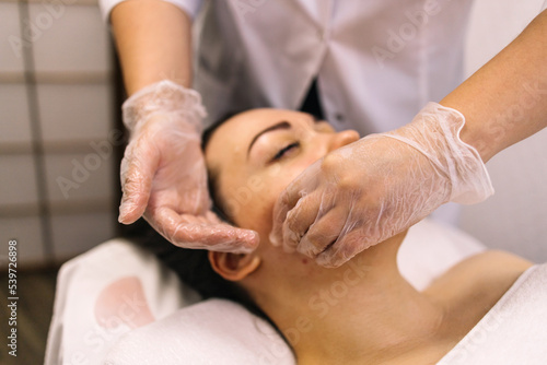 Принти на полотні Woman receiving facial buccal massage in beauty salon