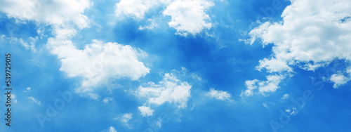 Beautiful clear light blue sky with white clouds in sunny day. Wallpaper background