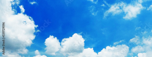 Beautiful clear light blue sky with white clouds in sunny day. Wallpaper background