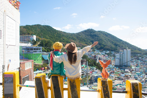 Woman traveller is sightseeing and looking at Gamcheon Culture Village in Busan, South Korea. © BUSARA