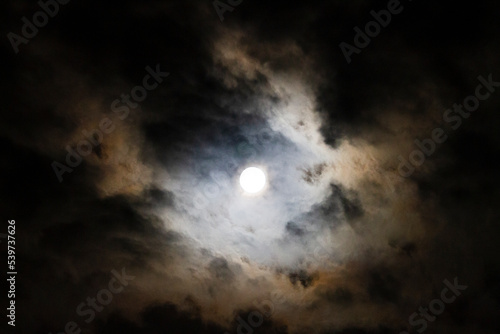 Full Moon in the night sky with clouds, traditionally the travel moon or blood moon