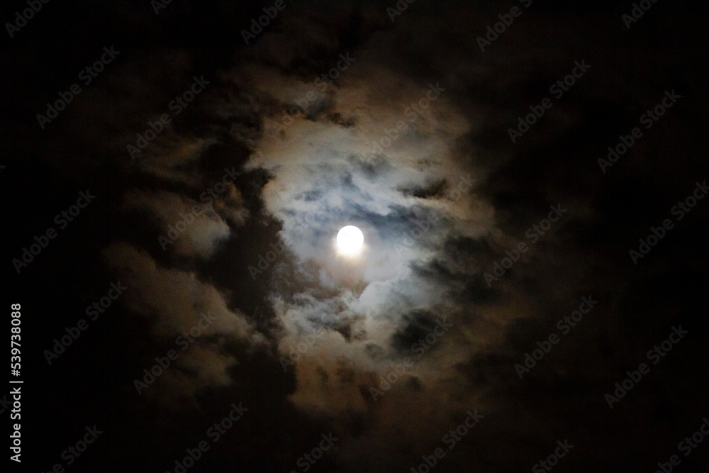 Moon in the night sky with clouds for Halloween, harvest or fall, blood moon
