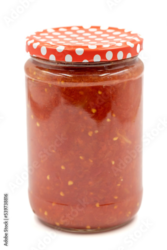 Canned tomato sauce in glass jar isolated on white background