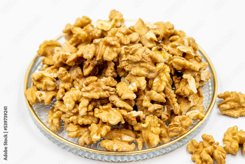 Walnut kernel in glass plate isolated on white background Walnut kernel in glass plate isolated on white background