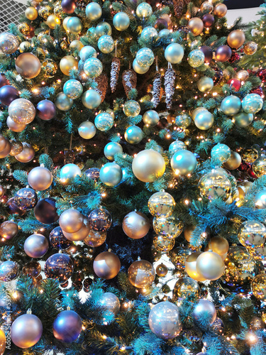 Closeup of Festively decorated Christmas tree with bright balls. Christmas tree toys.