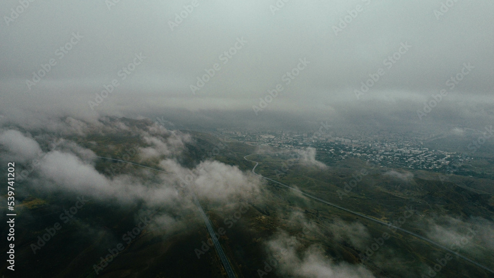 Cars are driving on the road in foggy weather - drone shots
