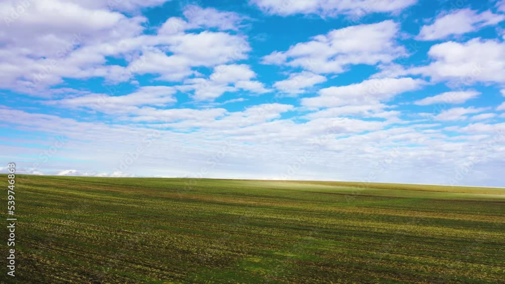 Flying along endless plowed agricultural field in autumn under a blue sky, drone aerial view. Flying along endless plowed agricultural field in autumn under a blue sky, drone aerial view.