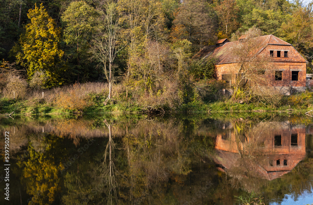 Autumn view of Berounka river with remains of the Dolany mill (Dolansky mlyn) and their reflections in the river. Pilsen, the Czech republic. Autumn view of Berounka river with remains of the Dolany mill (Dolansky mlyn) and their reflections in the river. Pilsen, the Czech republic.