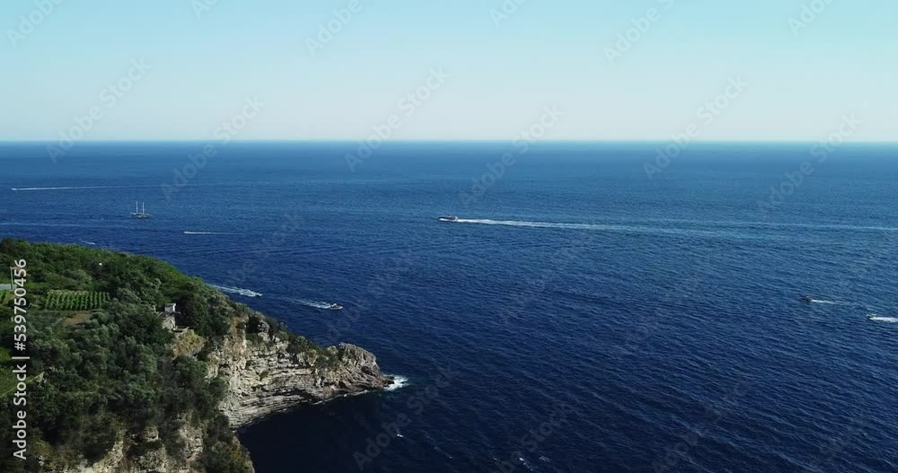 Beautiful aerial view of yachts and boats moving fast in the mediterranean sea. Drone flight over the mountain seashore. Sailing. Turquoise water. Rocky cliffs, blue water, floating boats, greenery. Beautiful aerial view of yachts and boats moving fast in the mediterranean sea. Drone flight over the mountain seashore. Sailing. Turquoise water. Rocky cliffs, blue water, floating boats, greenery.