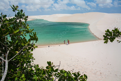 View of family in white dunes of the Lençóis Maranhenses National Park in brazil photo