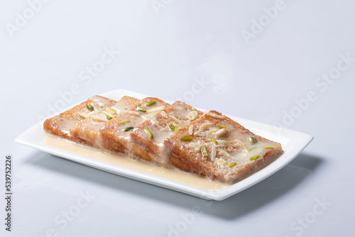 Shahi Tukda tukra dipped in Rabri or double ka meetha diwali sweet made with breadDelicious and creamy Shahi Tukrey (Bread Pudding).Shahi Tukda tukra 