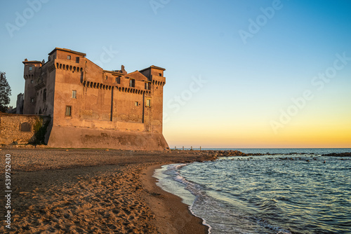 Santa severa castle with its golden beach photo