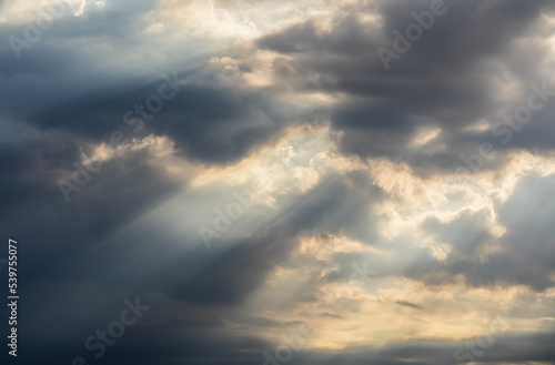 Amazing dramatic cloudy sky landscape with rays bursting out from the clouds. Iconic view of the sky in the morning. Nature landscapes around the world.