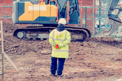 Obraz na plátne Excavator digging and levelling ground on construction site
