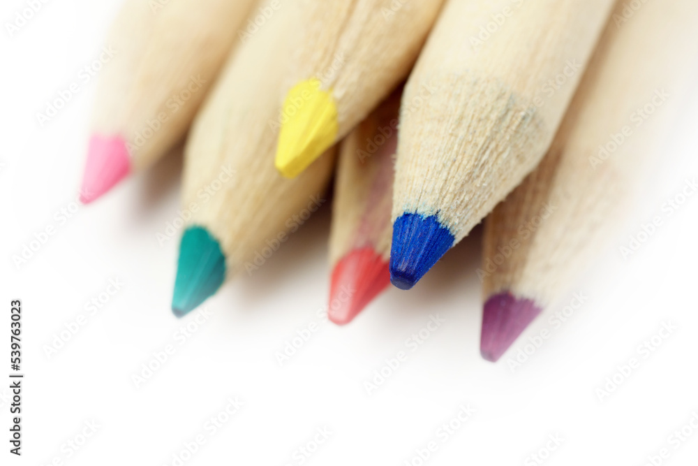Wooden coloured pencils close up concept art, text and office copy space. Isolated on white background. Wooden coloured pencils close up concept art, text and office copy space. Isolated on white background.