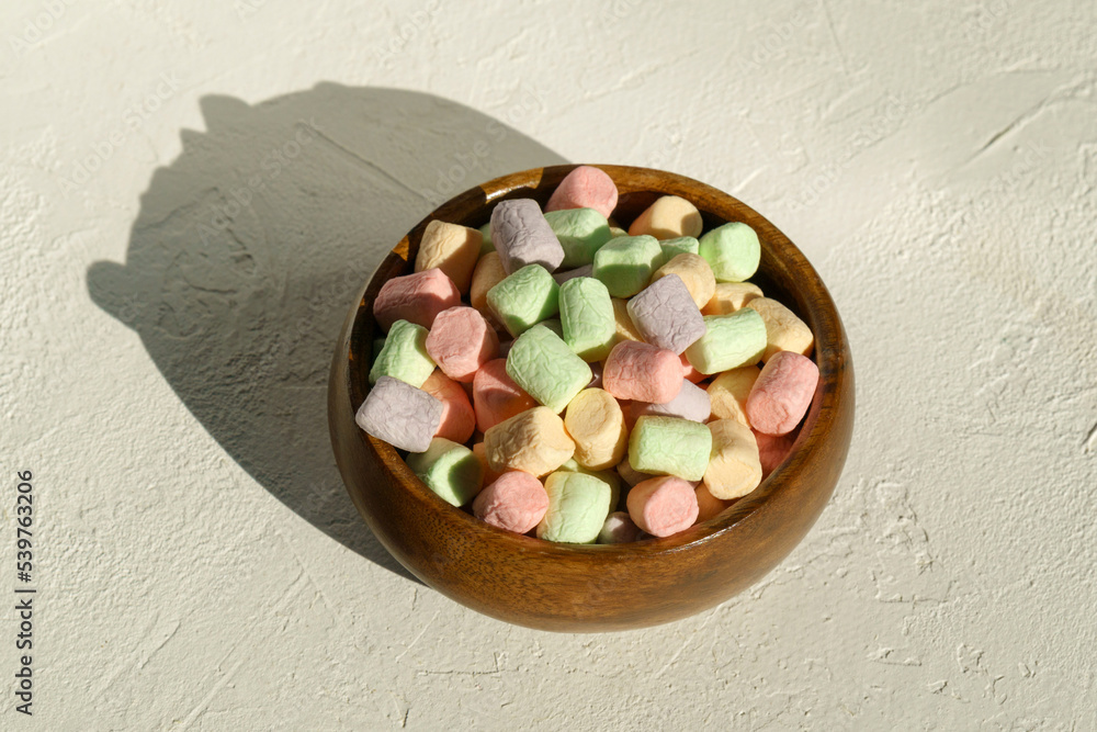 Multicolored marshmallows background. Mini powder cover candies. White background Multicolored marshmallows background. Mini powder cover candies. White background