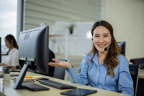 Asian telemarketing agent in call center office
