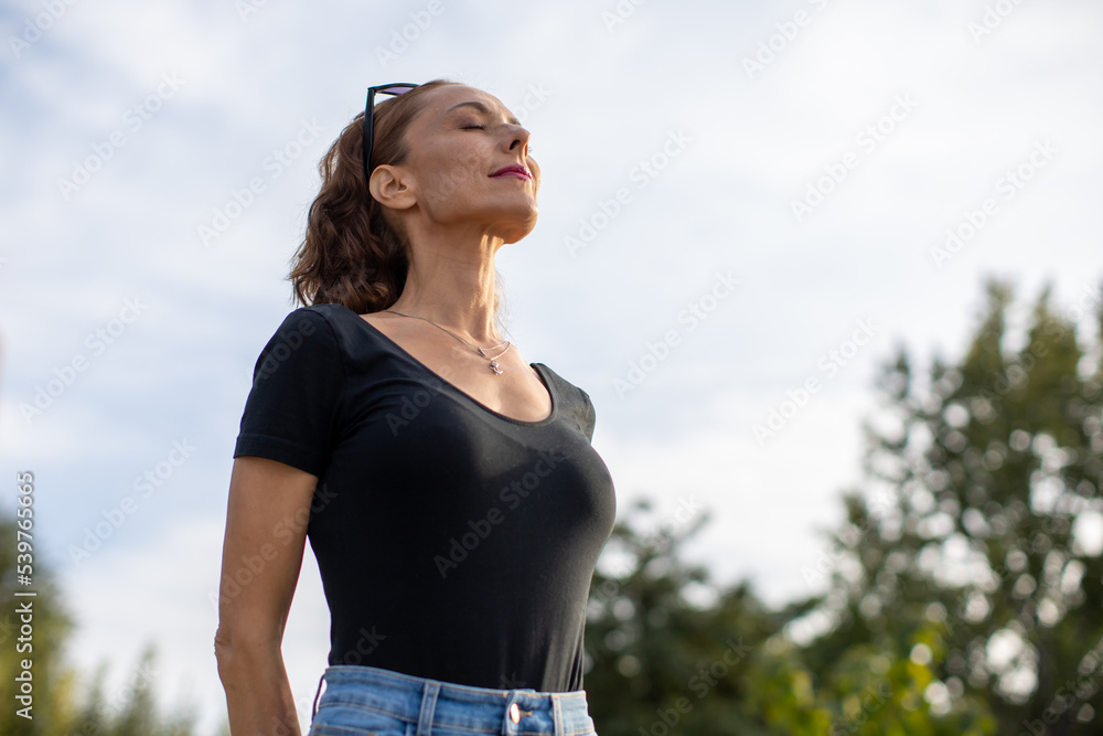 woman enjoying a beautiful day outdoors woman enjoying a beautiful day outdoors