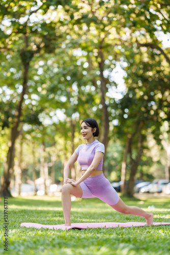 Pretty slim perfect body asian women wear sportswear to playing basic yoga compose. © NanSan