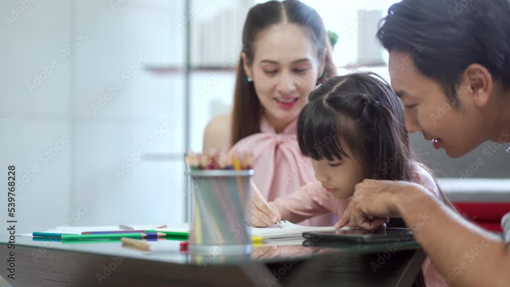 Parent teaching a homework for their daughter at home. Parent teaching a homework for their daughter at home.