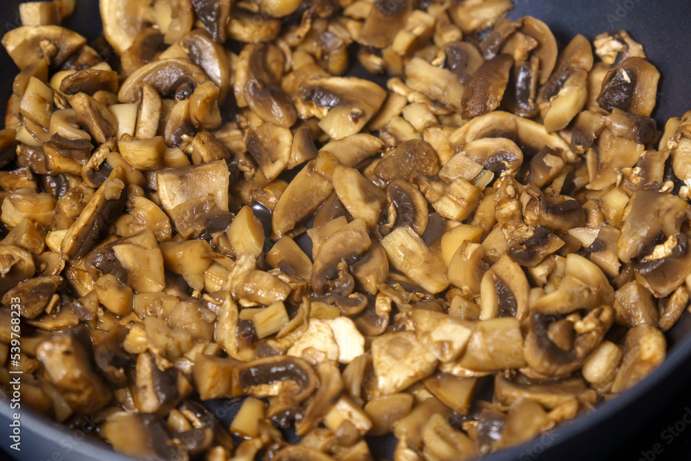 Fragrant homemade fried mushrooms in a frying pan, selective focus. Cooking homemade food Fragrant homemade fried mushrooms in a frying pan, selective focus. Cooking homemade food