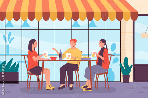 People in outdoor cafe. Man and woman sitting at table eating French fries and drinking beer. Friends communicating