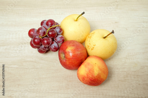 Assorted fresh fruit grapes apples and pears on the table