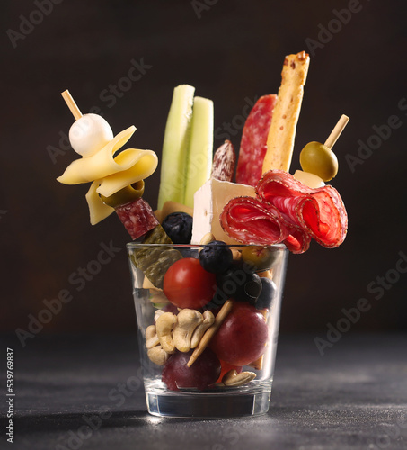 Jarcuterie in a glass, the modern version of charcuterie with various types of sausages and cheese photo