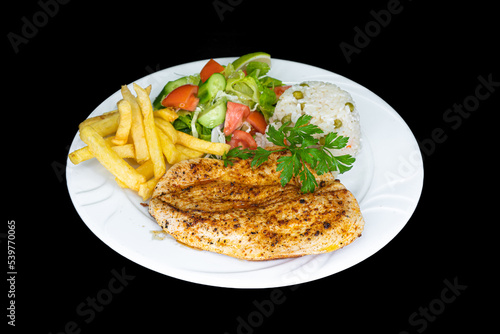 Grilled chicken breast in a white plate on a black background