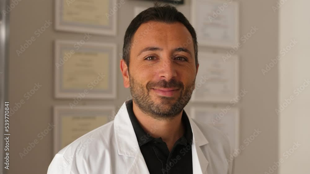 Male young doctor laughing in the clinic, looking at camera
Male young doctor laughing in the clinic, looking at camera