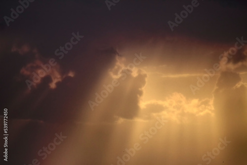Cloudy sky at sunset with sunbeams