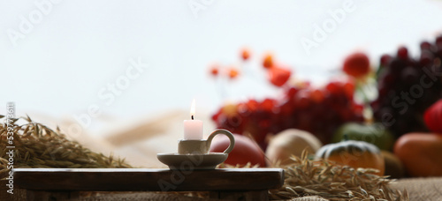 Church thanksgiving decoration and background with candles and fruits and grain wheat and barley 