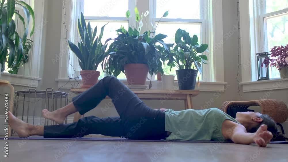 young woman indoors practicing yoga wellness healthy lifestyle stress mundfullnes america i canada young woman indoors practicing yoga wellness healthy lifestyle stress mundfullnes america i canada